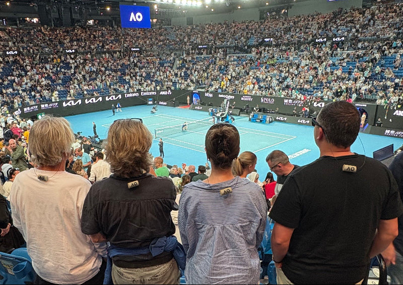 Four people wearing KORKZ custom wine cork sunglass straps watching a night match at the Australian Open, Melbourne, Australia, 2026