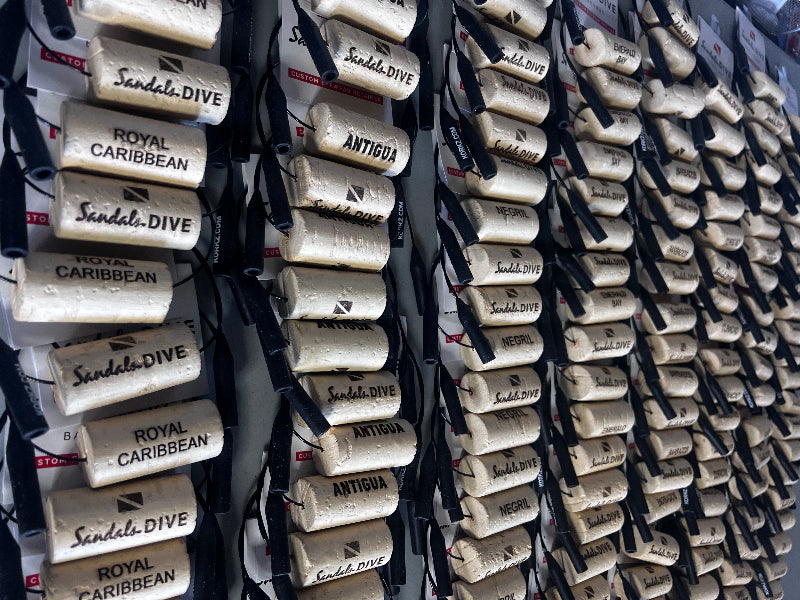 Rows of KORKZ custom laser engraved sunglass retainers bulk orders for Sandals Dive Royal Caribbean Antigua and Negril Caribbean resorts